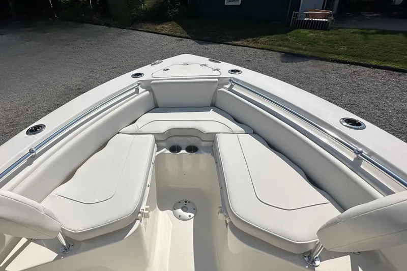 Slide: The Image of 2026 Key West 219 FS boat interior with white cushioned seating and cup holders. - 25