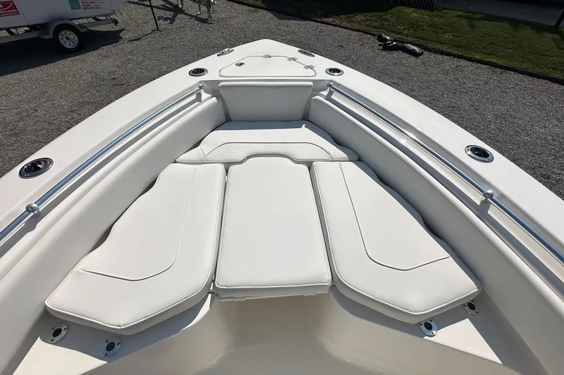 Slide: The Image of 2026 Key West 219 FS boat with white cushioned seating and stainless steel railings. - 26