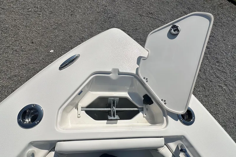 Slide: The Image of Open anchor compartment on 2026 Key West 219 FS boat, showing storage details. - 29