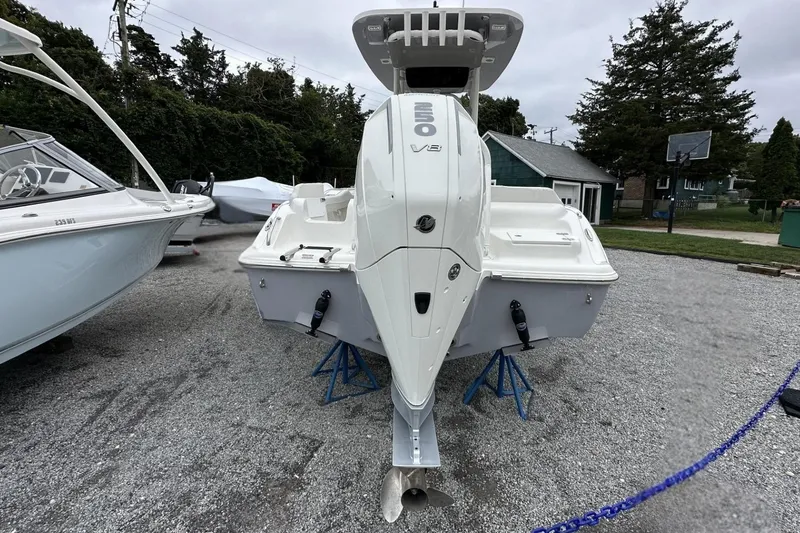 Slide: The Image of 2026 Key West 219 FS boat with V8 engine displayed outdoors on gravel. - 5