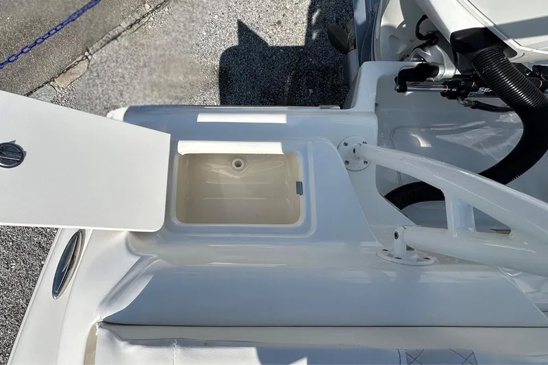 Slide: The Image of 2026 Key West 219 FS boat with open storage compartment on deck. - 7