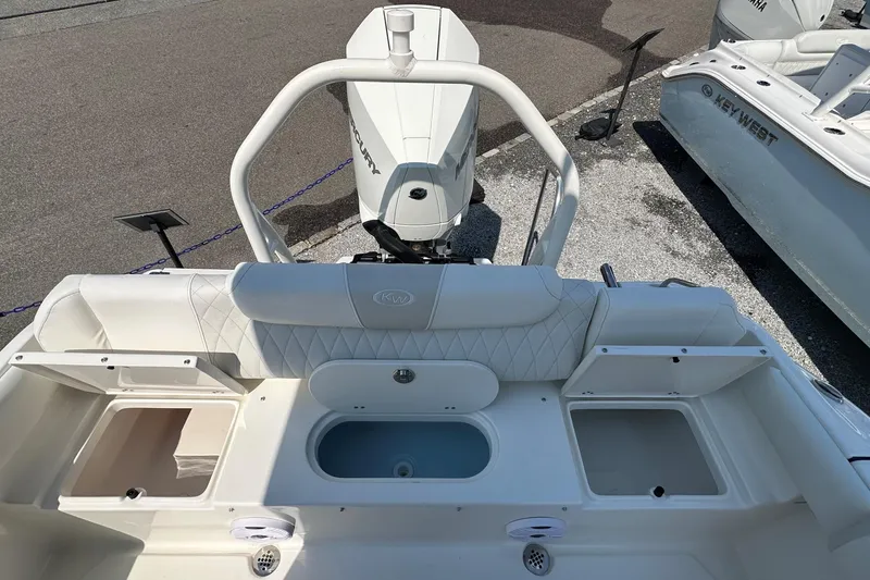 Slide: The Image of 2026 Key West 219 FS boat interior with seating and storage compartments. - 9