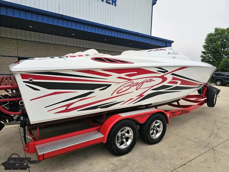 Slide: The Image of 2005 Baja 25 Outlaw speedboat with red and black graphics on a matching trailer. - 10