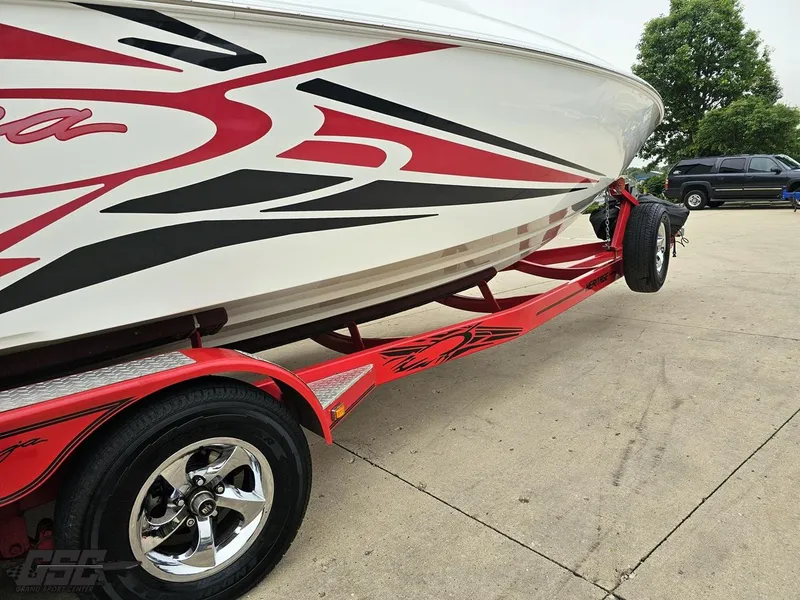 Slide: The Image of 2005 Baja 25 Outlaw boat on a red trailer with bold graphics. - 11