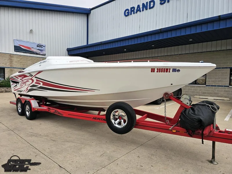 Slide: The Image of 2005 Baja 25 Outlaw boat on red trailer outside Grand Sport Center. - 13