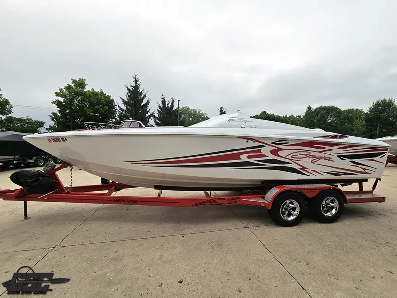 Slide: The Image of 2005 Baja 25 Outlaw boat on red trailer, featuring sleek design and bold graphics. - 22