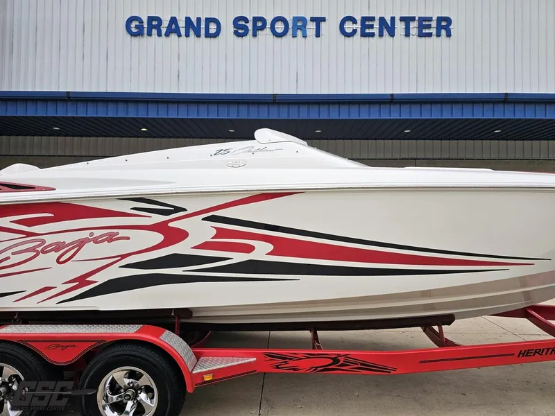 Slide: The Image of 2005 Baja 25 Outlaw boat with red graphics at Grand Sport Center. - 3