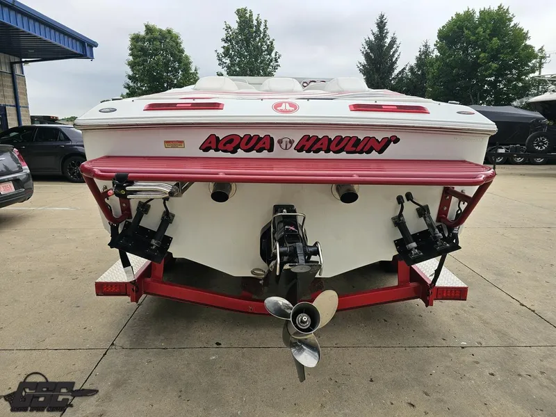 Slide: The Image of 2005 Baja 25 Outlaw boat on trailer, rear view with "Aqua Haulin'" text. - 35