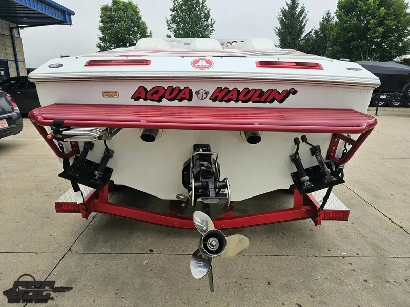 Slide: The Image of 2005 Baja 25 Outlaw boat with "Aqua Haulin'" text, rear view on trailer. - 36