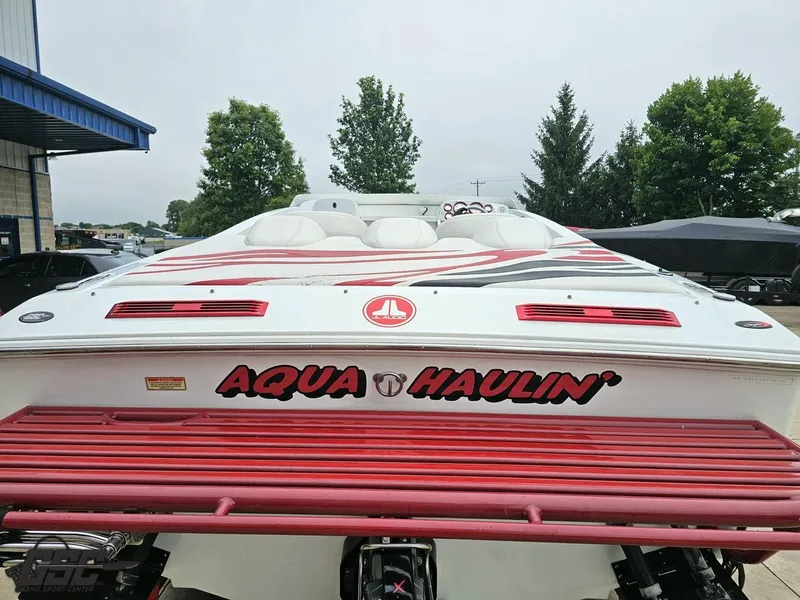 Slide: The Image of 2005 Baja 25 Outlaw boat with "Aqua Haulin'" text, parked outdoors. - 37