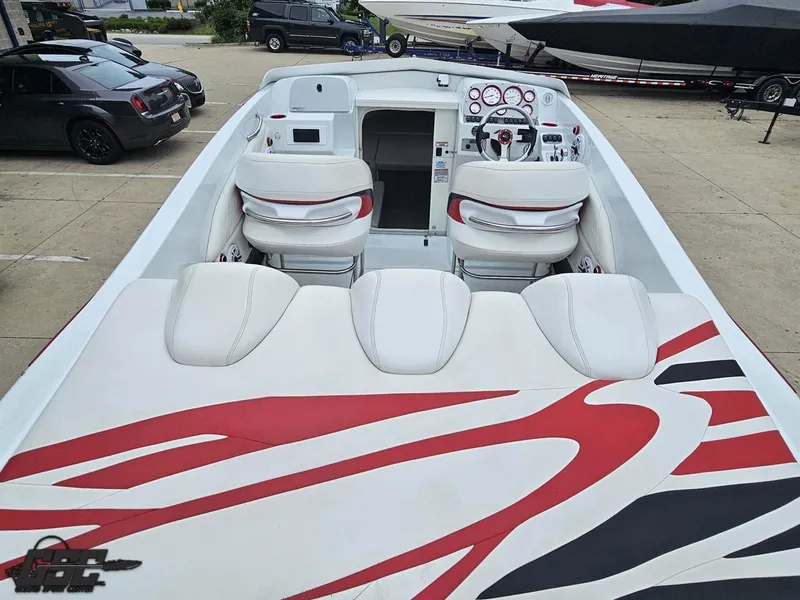 Slide: The Image of 2005 Baja 25 Outlaw boat interior with red and white seating and dashboard. - 43