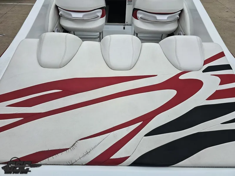 Slide: The Image of 2005 Baja 25 Outlaw boat interior with red and black patterned upholstery. - 44
