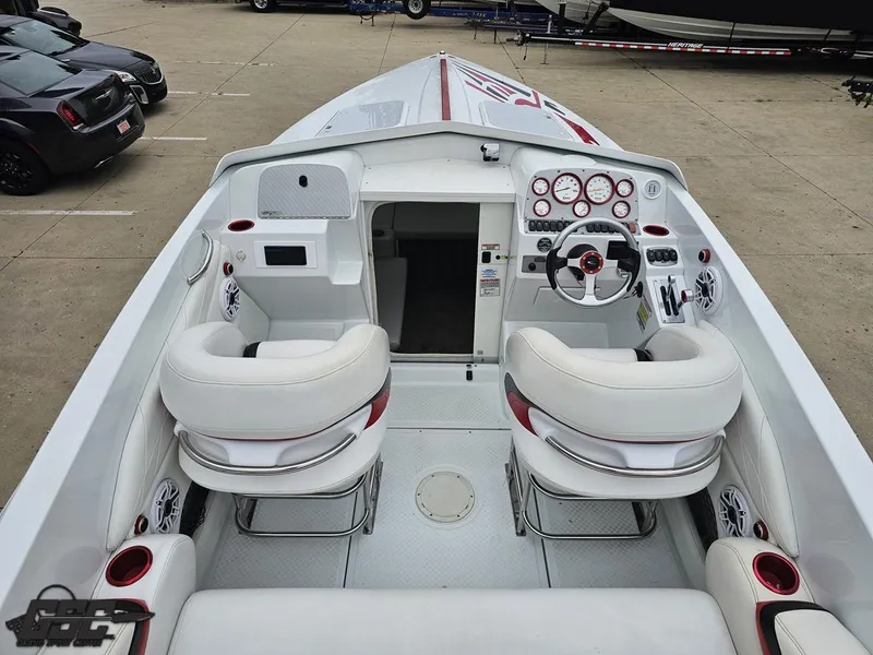 Slide: The Image of 2005 Baja 25 Outlaw boat interior with white seating and control panel. - 47