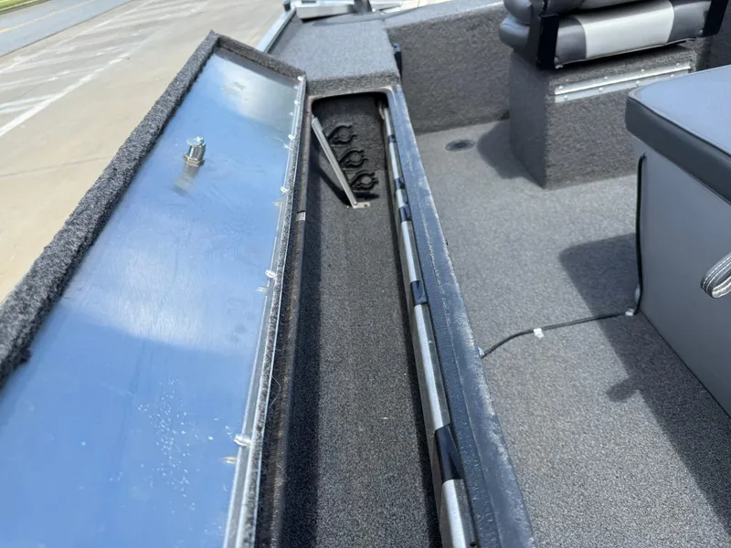 Slide: The Image of 2018 Lowe Stryker 16 boat interior with storage compartment and seating. - 17