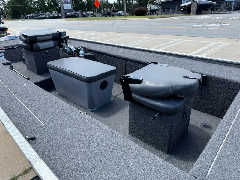 Slide: The Image of 2018 Lowe Stryker 16 boat interior with gray seating and storage compartments. - 19