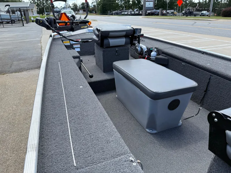 Slide: The Image of 2018 Lowe Stryker 16 boat interior with seating and equipment, parked on a street. - 22