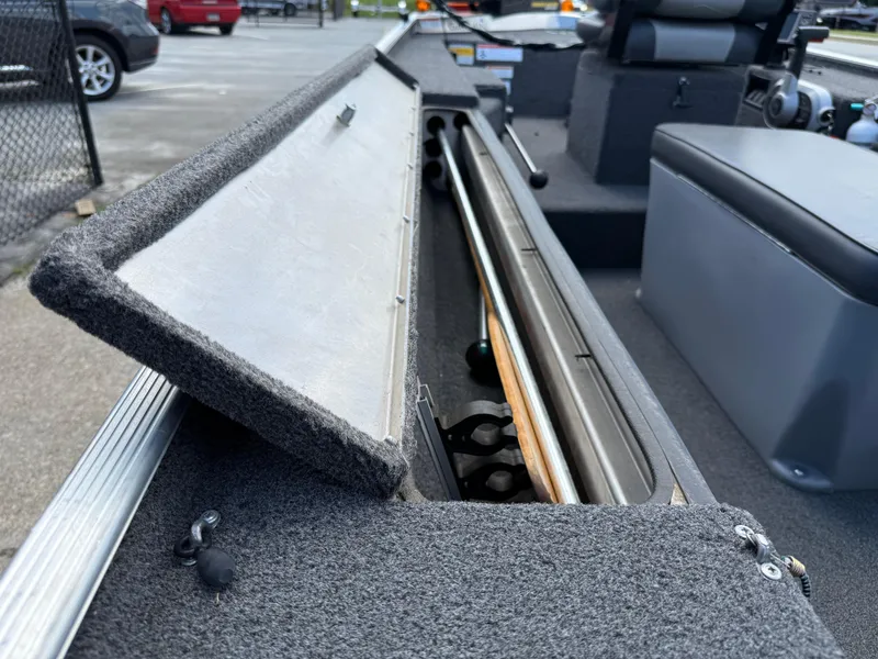 Slide: The Image of Open storage compartment in a 2018 Lowe Stryker 16 boat, showing interior details. - 24