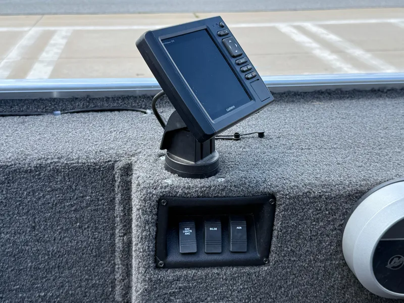 Slide: The Image of Control panel of a 2018 Lowe Stryker 16 boat with Garmin display and switches. - 29