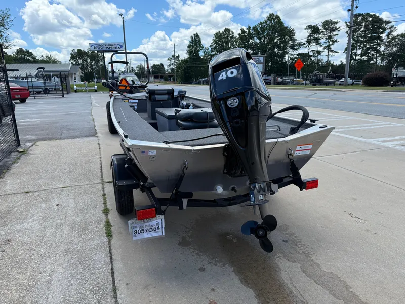 Slide: The Image of 2018 Lowe Stryker 16 boat with 40 HP motor on a trailer, parked outdoors. - 4