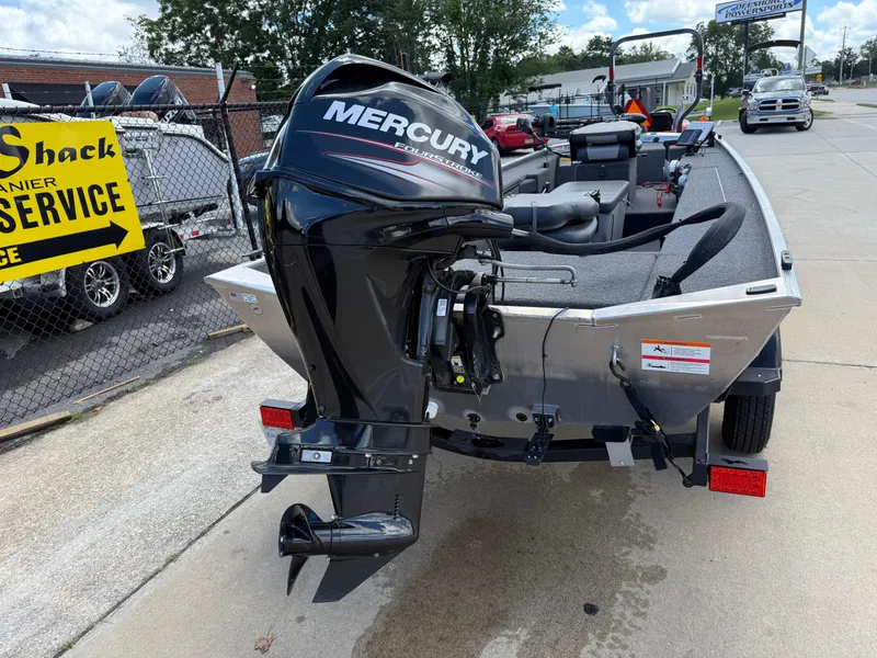 Slide: The Image of 2018 Lowe Stryker 16 boat with Mercury outboard motor, parked near service area. - 5
