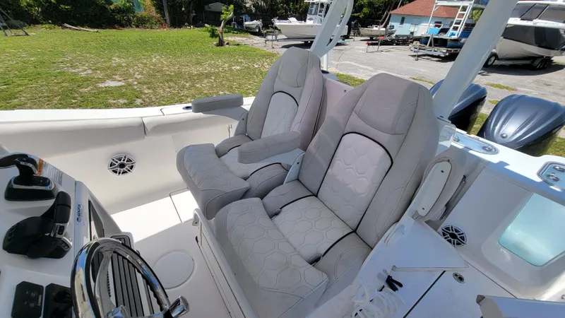 Slide: The Image of 2024 Sea Fox 288 Commander boat interior with plush seating and control panel. - 10