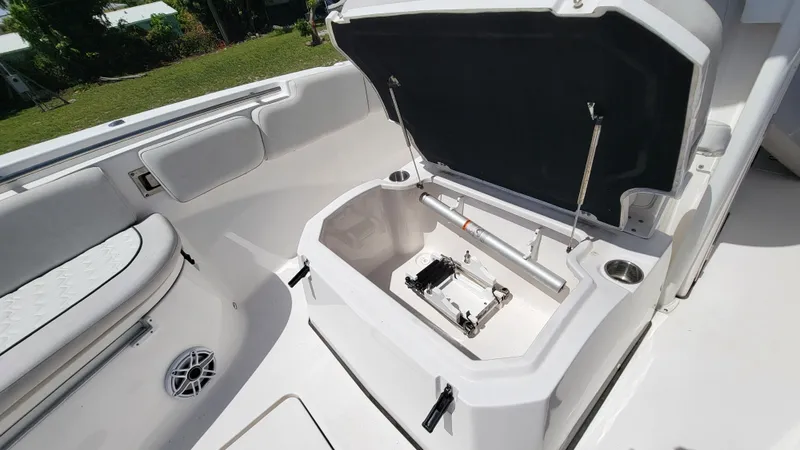 Slide: The Image of 2024 Sea Fox 288 Commander boat storage compartment with open hatch and seating area. - 11