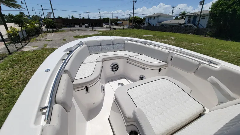 Slide: The Image of 2024 Sea Fox 288 Commander boat interior with white cushioned seating and speakers. - 17