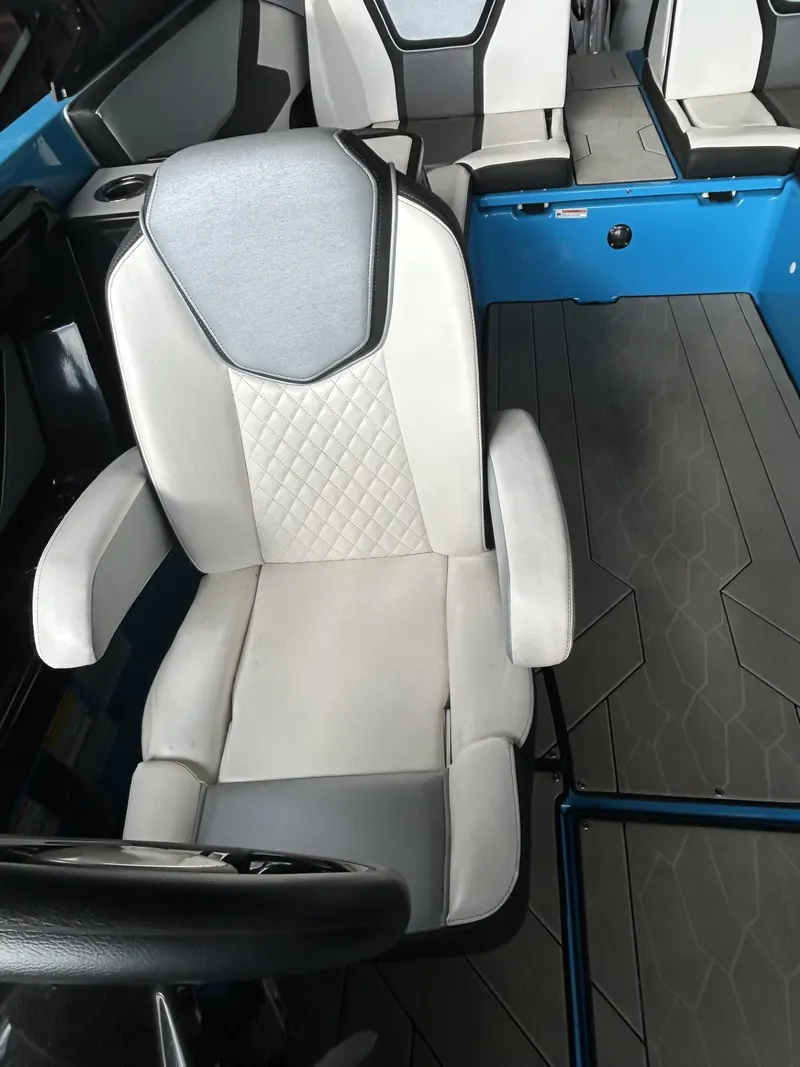 Slide: The Image of 2023 Yamaha Boats 255 XD interior with white and gray seating and modern design. - 10