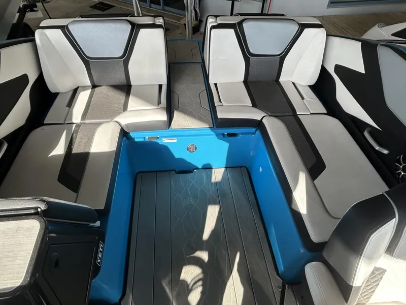 Slide: The Image of 2023 Yamaha Boats 255 XD interior with modern seating and blue accents. - 5