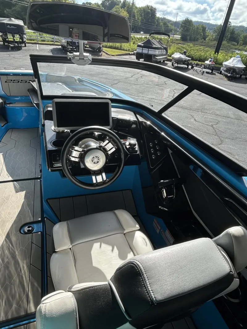 Slide: The Image of Interior of 2023 Yamaha Boats 255 XD, featuring steering wheel and dashboard controls. - 6