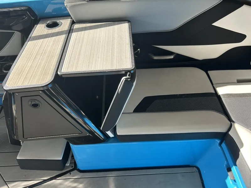 Slide: The Image of 2023 Yamaha Boats 255 XD interior seating with foldable table and cup holder. - 8