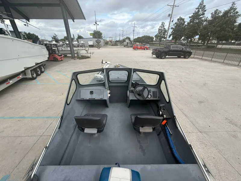 Slide: The Image of Interior view of a 2015 Hanko 17 boat, featuring dual seats and steering console. - 14