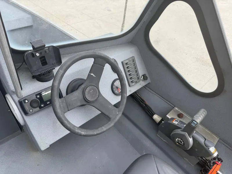 Slide: The Image of Interior of a 2015 Hanko 17 boat showing steering wheel and control panel. - 16