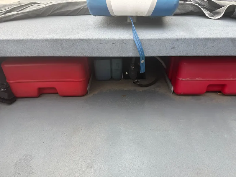Slide: The Image of Storage compartment of a 2015 Hanko 17 boat with red containers and blue strap. - 21
