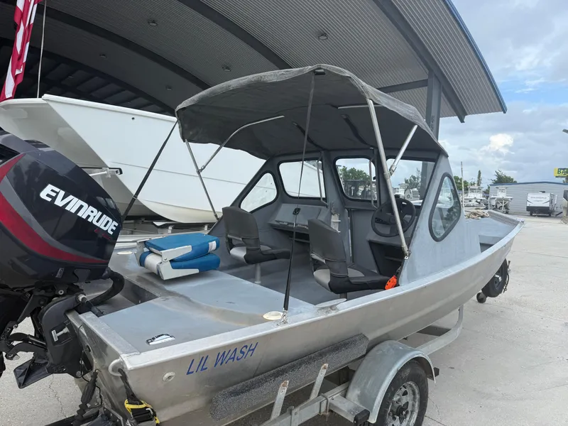 Slide: The Image of Aluminum Hanko 17 boat with Evinrude motor, parked on trailer, 2015 model. - 23