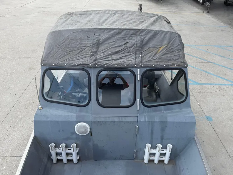 Slide: The Image of Hanko 17 boat, 2015 model, with covered cabin and rod holders, parked on concrete. - 25