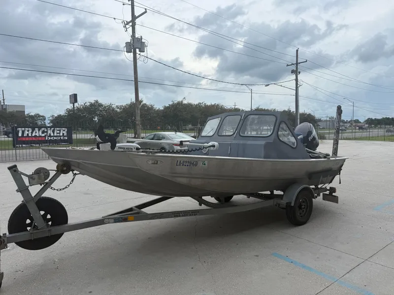Slide: The Image of Aluminum Hanko 17 boat on trailer, parked outdoors, cloudy sky background. - 8