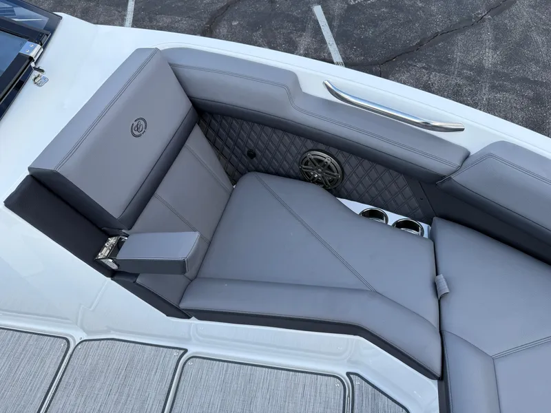 Slide: The Image of 2025 Cobalt R6 boat interior with gray leather seating and cup holders. - 11