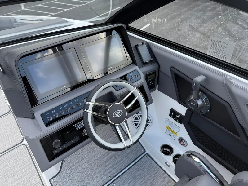 Slide: The Image of 2025 Cobalt R6 boat dashboard with dual screens and modern steering wheel. - 16