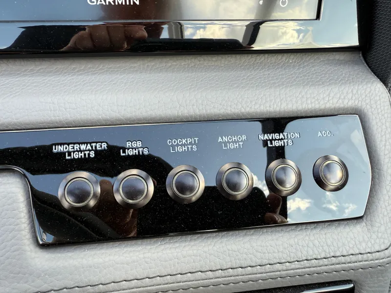 Slide: The Image of Control panel of a 2025 Cobalt R6 boat with various light switches. - 20
