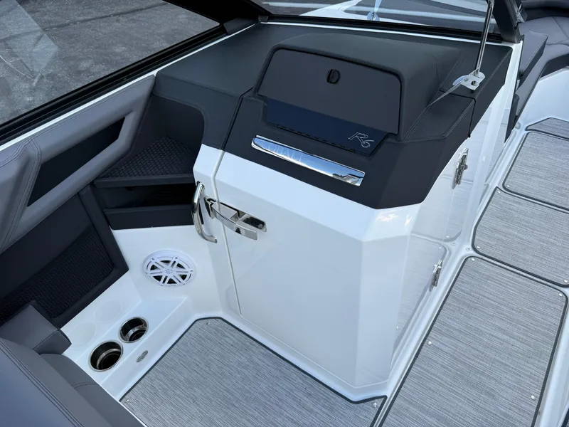 Slide: The Image of 2025 Cobalt R6 boat interior with sleek design, cup holders, and speaker system. - 25