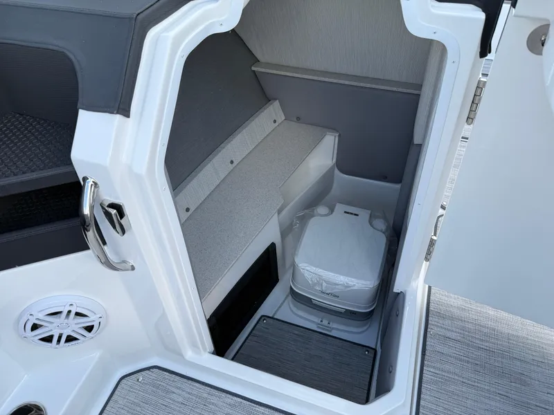 Slide: The Image of 2025 Cobalt R6 boat interior with compact toilet and seating area. - 26