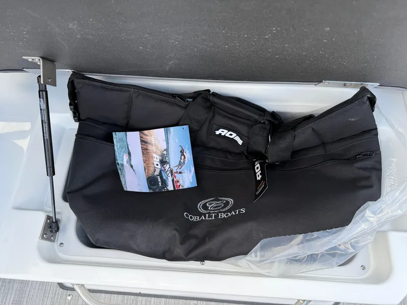 Slide: The Image of Black Cobalt Boats bag in storage compartment of 2025 Cobalt R6. - 28