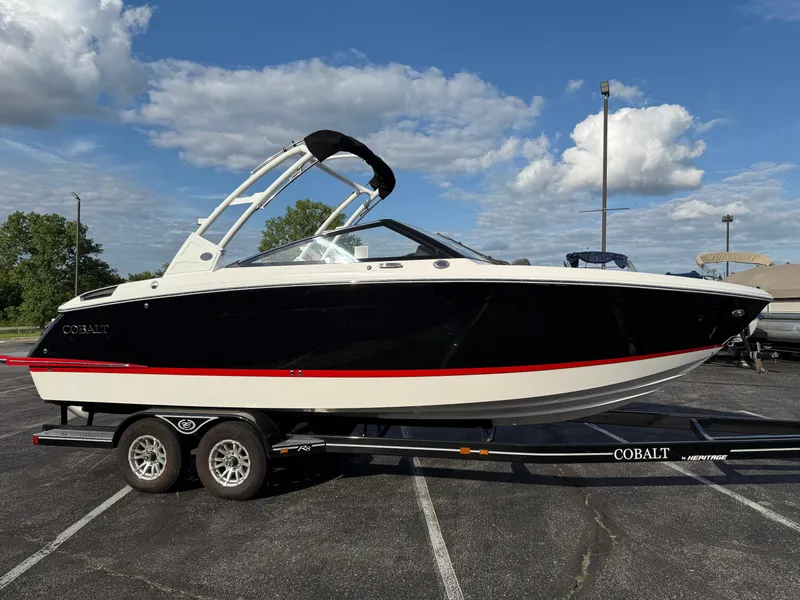 Slide: The Image of 2025 Cobalt R6 boat on trailer under blue sky with clouds. - 3