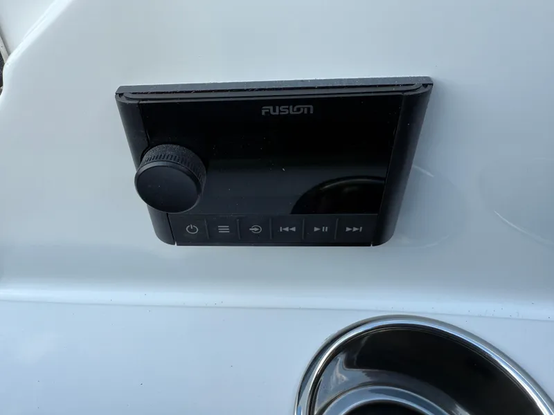 Slide: The Image of Control panel on a 2025 Cobalt R6 boat, featuring a Fusion audio system. - 32