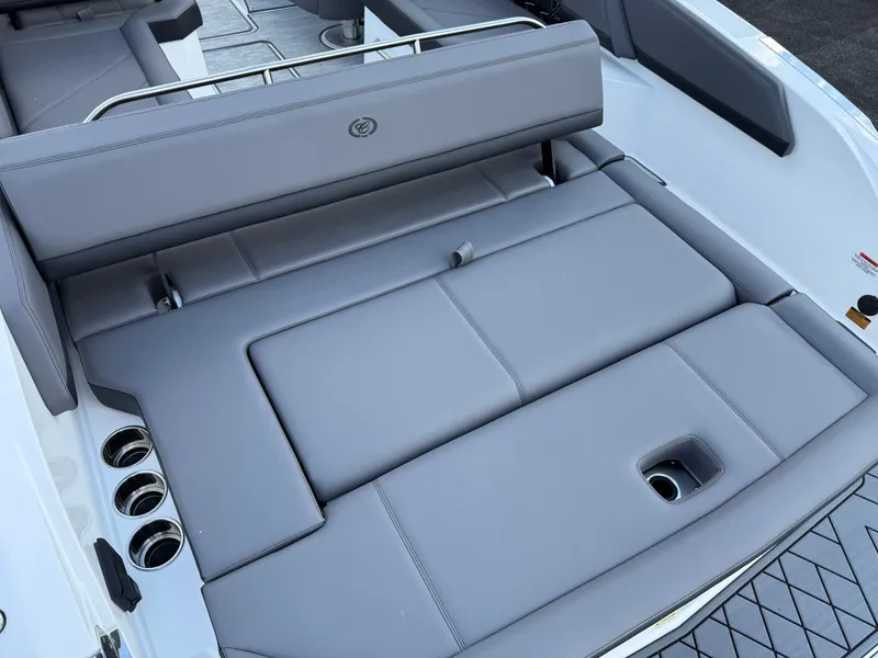 Slide: The Image of 2025 Cobalt R6 boat interior with gray cushioned seating and cup holders. - 34