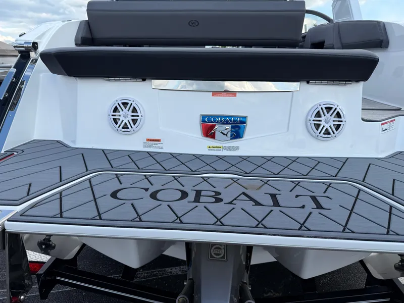 Slide: The Image of 2025 Cobalt R6 boat rear view with speakers and logo on deck. - 7