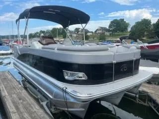 Slide: The Image of 2018 Avalon Catalina 2385QL pontoon boat docked on a sunny day. - 1