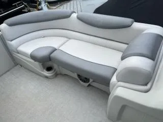Slide: The Image of 2018 Avalon Catalina 2385QL boat seating, featuring gray and white cushioned upholstery. - 3