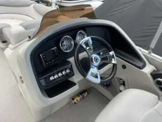 Slide: The Image of 2018 Avalon Catalina 2385QL boat dashboard with steering wheel and gauges. - 6